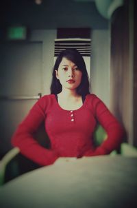 Portrait of woman sitting at home