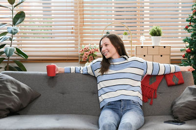 Portrait of boy sitting on sofa at home