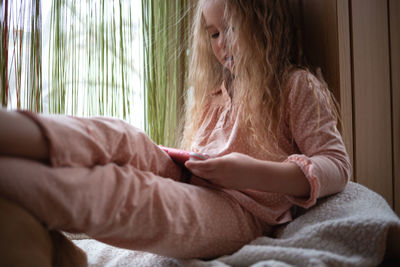 Young woman sleeping on bed at home