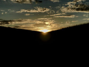 Silhouette landscape against sky during sunset