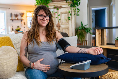 Young woman sitting at home