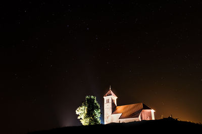 Low angle view of bell tower against sky at night