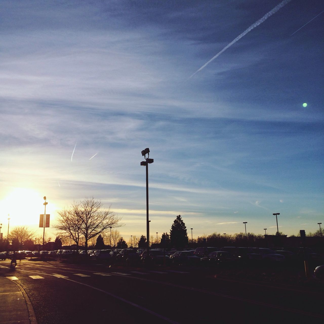 street light, road, sky, transportation, street, cloud - sky, the way forward, lighting equipment, road marking, illuminated, car, city, silhouette, sunset, built structure, dusk, outdoors, cloud, tree, no people