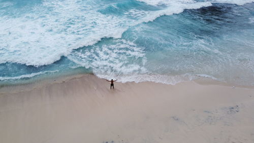 High angle view of man standing on beach