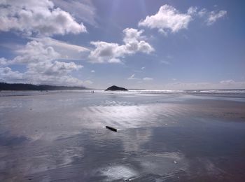 Scenic view of calm sea against cloudy sky