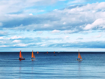 Sailboat sailing on sea against sky