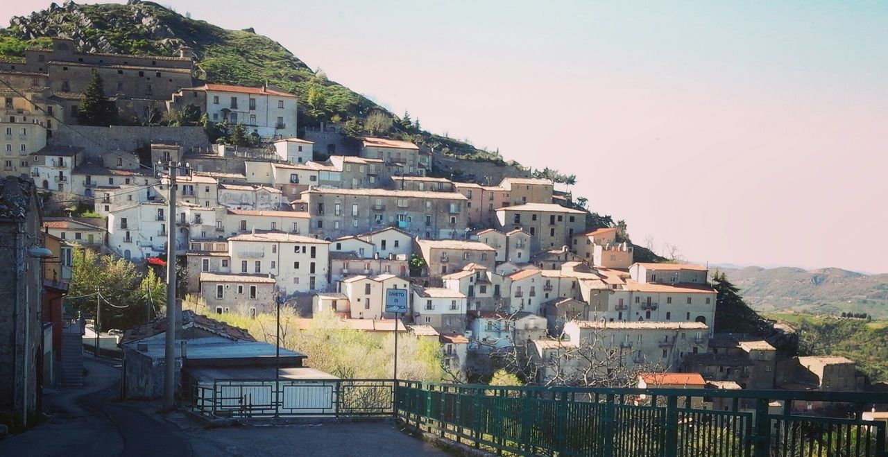 architecture, built structure, building exterior, clear sky, outdoors, no people, day, mountain, town, tree, nature, sky