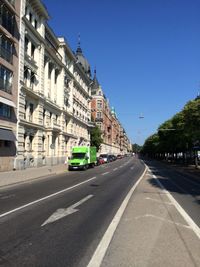 View of city street against blue sky