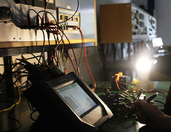 Man using laptop on table in illuminated room