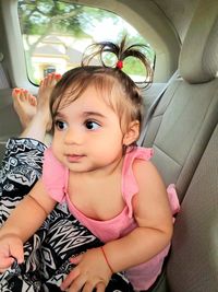 Portrait of cute girl in car