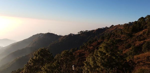 Scenic view of mountains against sky at sunset