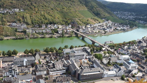 High angle view of townscape by river in city