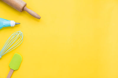 High angle view of colored pencils on yellow table