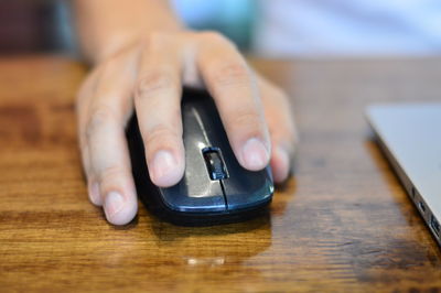 Close-up of hands working on table