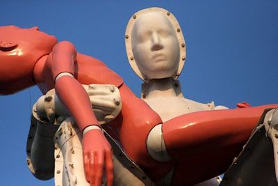 Low angle view of sculpture against clear blue sky