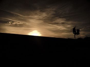 Low angle view of silhouette trees against sky at sunset