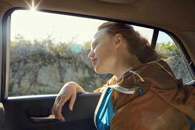 Young woman in a car looking out of window