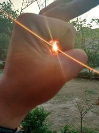 Close-up of hand holding sun