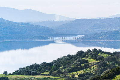 Scenic view of lake and mountains against sky