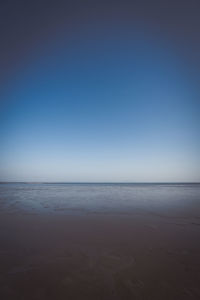 View of beach against blue sky