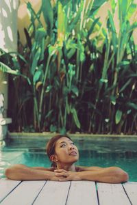 Portrait of young woman relaxing in swimming pool