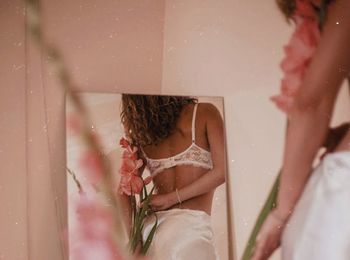 Rear view of woman sitting in bathroom