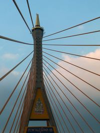 Low angle view of suspension bridge against sky