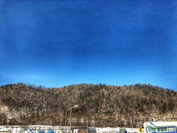 Scenic view of snowcapped mountains against clear blue sky