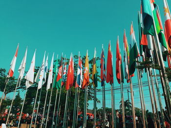 Low angle view of flags against clear sky