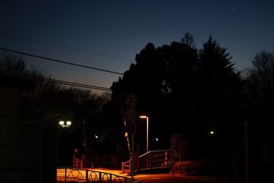 View of illuminated street lights at night