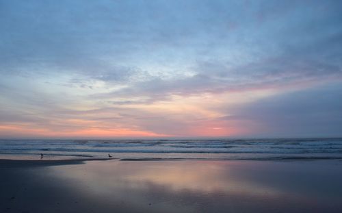 Scenic view of sea against sky at sunset