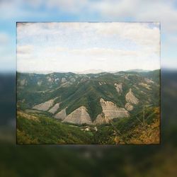 Scenic view of landscape against cloudy sky