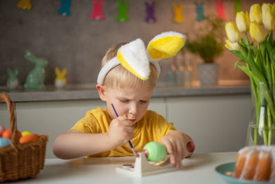 Portrait of boy playing with toy on table