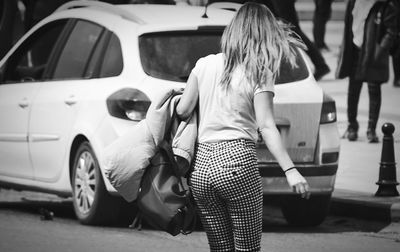 Rear view of woman on street in city