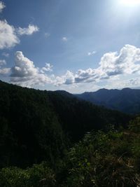 Countryside landscape against mountain range