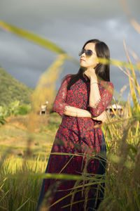 Young woman standing on field