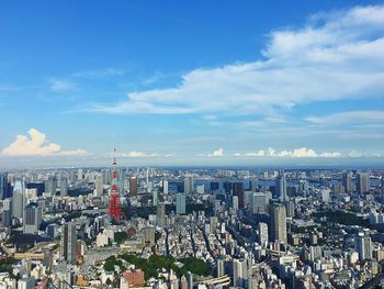 View of cityscape against cloudy sky