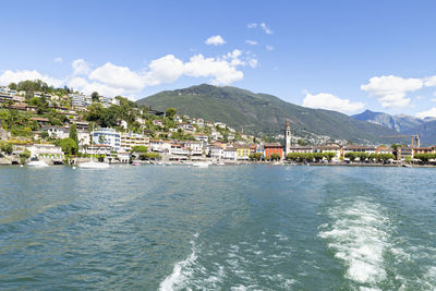 Scenic view of sea by buildings against sky