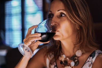 Close-up portrait of a woman drinking glass