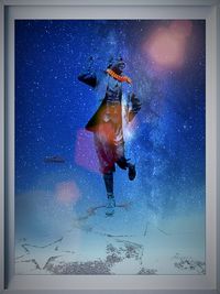 Low angle view of woman against blue sky