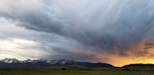 Scenic view of mountains against cloudy sky