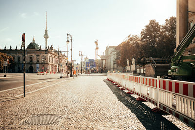 View of city street and buildings against sky