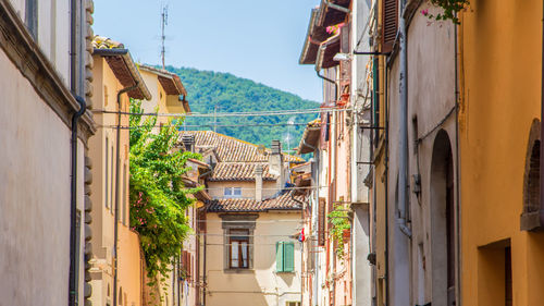 Residential buildings in town against sky