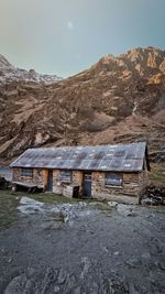 Houses by mountain against sky