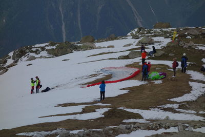 People on snowcapped mountains during winter