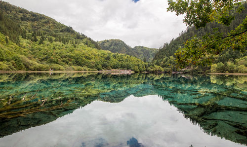 Scenic view of lake and mountains against sky