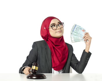 Young woman wearing mask against white background