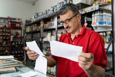 Full length of a man holding paper