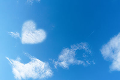 Low angle view of vapor trail against blue sky