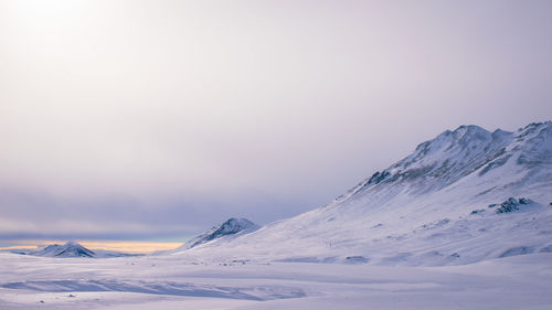 Scenic view of snowcapped mountains against clear sky